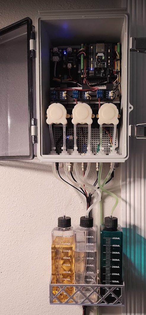 The mounted enclosure with pH-up, pH-down and nutrient dosing bottles.